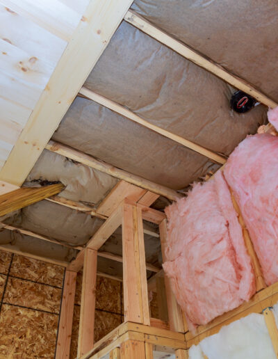 Covering view of layers of pink fiberglass insulation cold barrier
